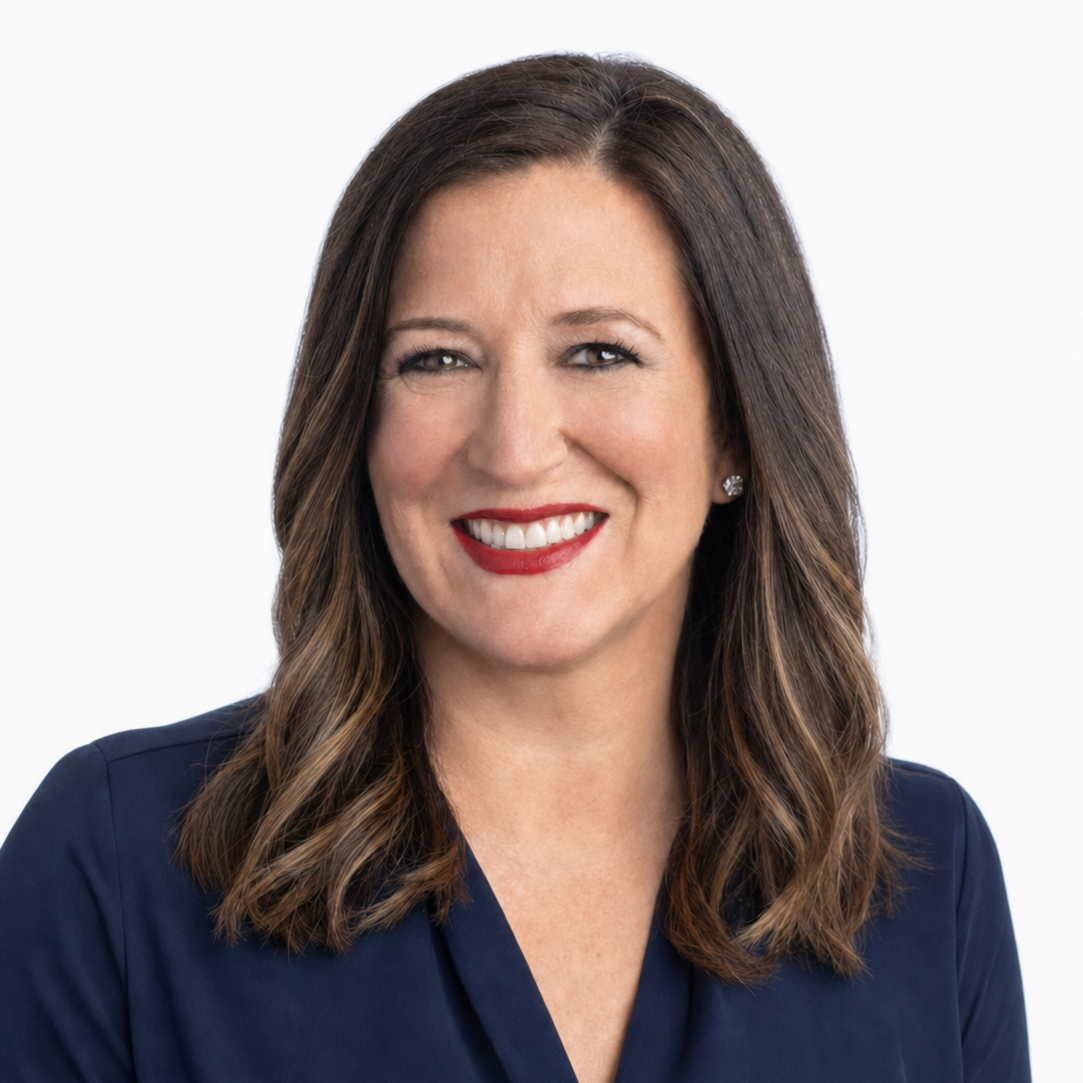 A professional studio headshot of Colleen Carcone smiling warmly against a clean, plain white background, cropped within a circular frame.